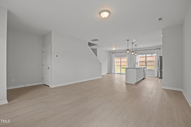 5404 Rutledgeville Ln, Knightdale, NC 27545 - unfurnished living room featuring a sink and light wood finished floors