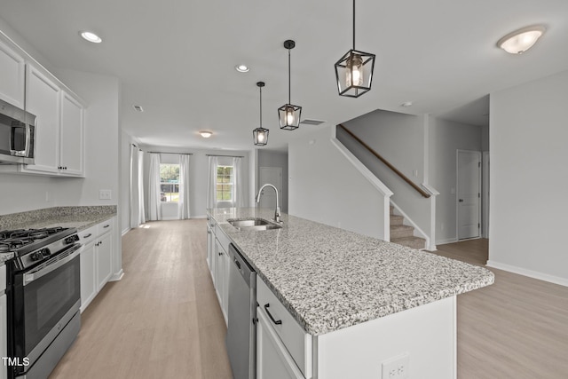 5404 Rutledgeville Ln, Knightdale, NC 27545 - kitchen featuring stainless steel appliances, light wood-style floors, white cabinetry, and recessed lighting
