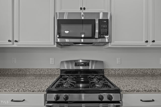 5404 Rutledgeville Ln, Knightdale, NC 27545 - kitchen featuring stainless steel appliances, white cabinetry, and light stone counters