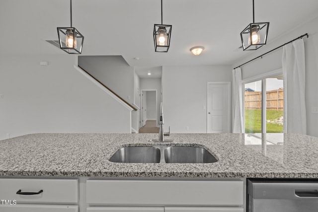 5404 Rutledgeville Ln, Knightdale, NC 27545 - kitchen featuring dishwasher, light stone counters, white cabinetry, and hanging light fixtures
