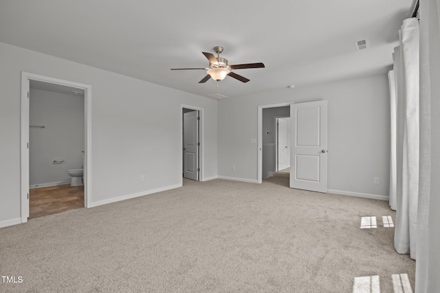 5404 Rutledgeville Ln, Knightdale, NC 27545 - unfurnished bedroom featuring light carpet, ensuite bath, and a ceiling fan
