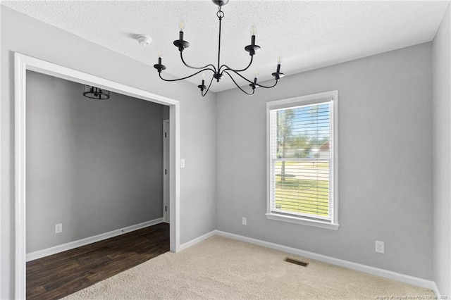 3326 Donnett Dr, Spring Lake, NC 28390 - carpeted spare room featuring a chandelier, a textured ceiling, and a smoke detector