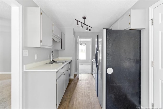 3326 Donnett Dr, Spring Lake, NC 28390 - kitchen with stainless steel appliances, light countertops, light wood finished floors, white cabinets, and track lighting