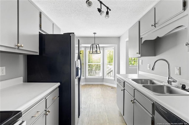 3326 Donnett Dr, Spring Lake, NC 28390 - kitchen with stainless steel appliances, light wood-style floors, a textured ceiling, light countertops, and track lighting