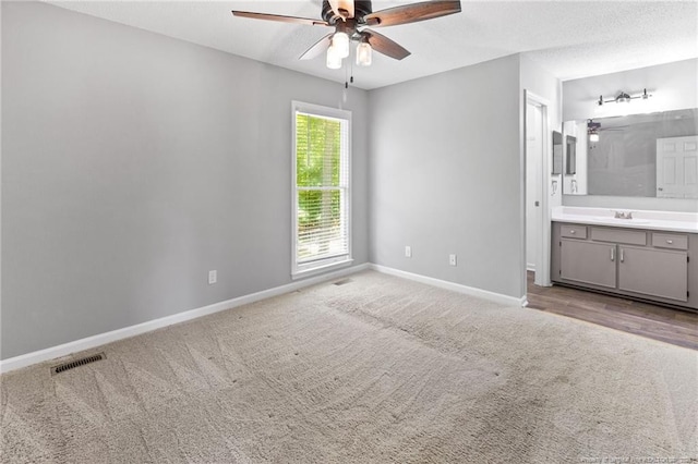 3326 Donnett Dr, Spring Lake, NC 28390 - unfurnished bedroom with light carpet, connected bathroom, and ceiling fan