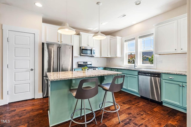 438 Granite Mill Blvd, Chapel Hill, NC 27516 - kitchen featuring appliances with stainless steel finishes, dark wood-style flooring, white cabinets, and recessed lighting