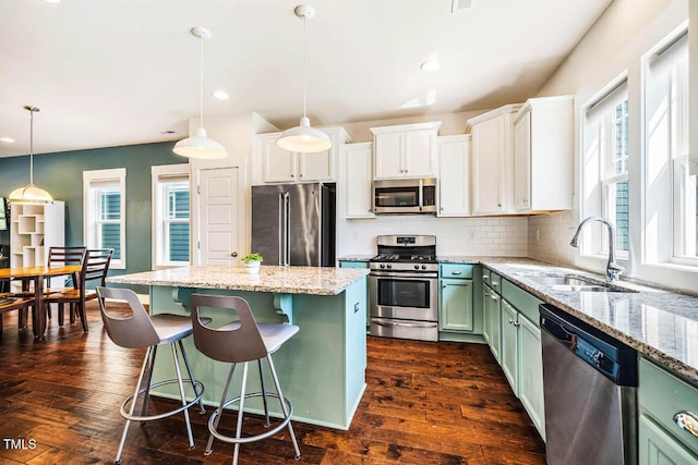 438 Granite Mill Blvd, Chapel Hill, NC 27516 - kitchen featuring stainless steel appliances, green cabinets, a center island, dark wood finished floors, and recessed lighting