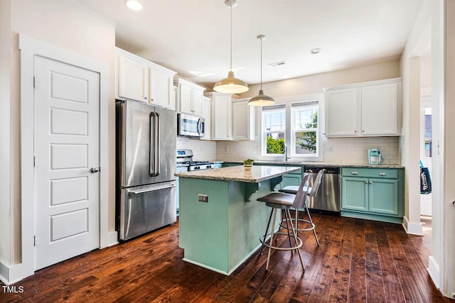 438 Granite Mill Blvd, Chapel Hill, NC 27516 - kitchen featuring appliances with stainless steel finishes, decorative backsplash, white cabinetry, dark wood-type flooring, and recessed lighting
