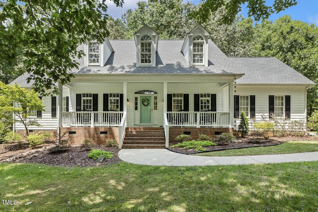 8916 Timberland Dr, Wake Forest, NC 27587 - cape cod-style house with crawl space, a porch, roof with shingles, and a front lawn