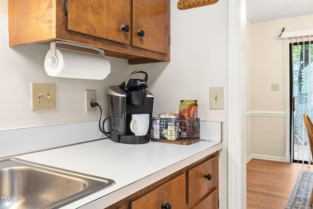 4316 American Dr, Durham, NC 27705 - kitchen featuring brown cabinets, light countertops, and wood finished floors