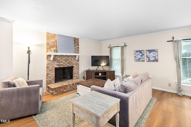 4316 American Dr, Durham, NC 27705 - living room with wood finished floors, ornamental molding, and a brick fireplace