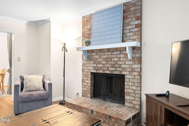 4316 American Dr, Durham, NC 27705 - living room with crown molding, wood finished floors, a brick fireplace, and a textured ceiling
