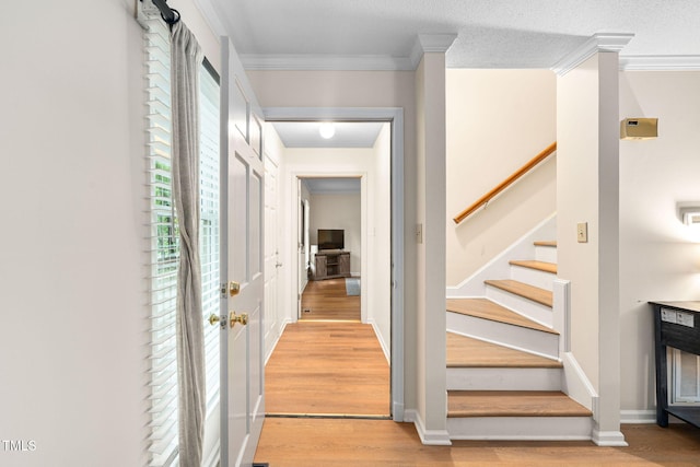 4316 American Dr, Durham, NC 27705 - entrance foyer featuring light wood-style flooring, stairway, and crown molding