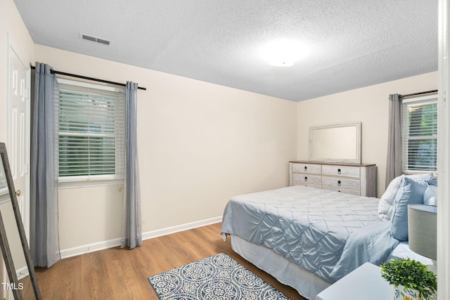 4316 American Dr, Durham, NC 27705 - bedroom featuring wood finished floors and a textured ceiling