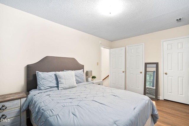 4316 American Dr, Durham, NC 27705 - bedroom featuring wood finished floors and a textured ceiling