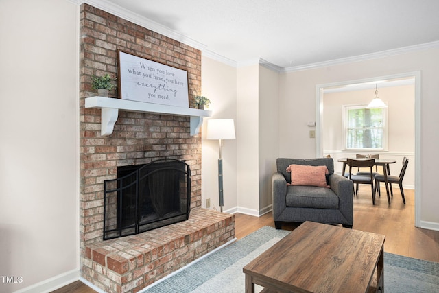 4316 American Dr, Durham, NC 27705 - living area featuring ornamental molding, a brick fireplace, and wood finished floors