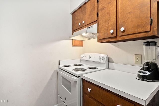 4316 American Dr, Durham, NC 27705 - kitchen with white electric stove, under cabinet range hood, light countertops, and brown cabinetry