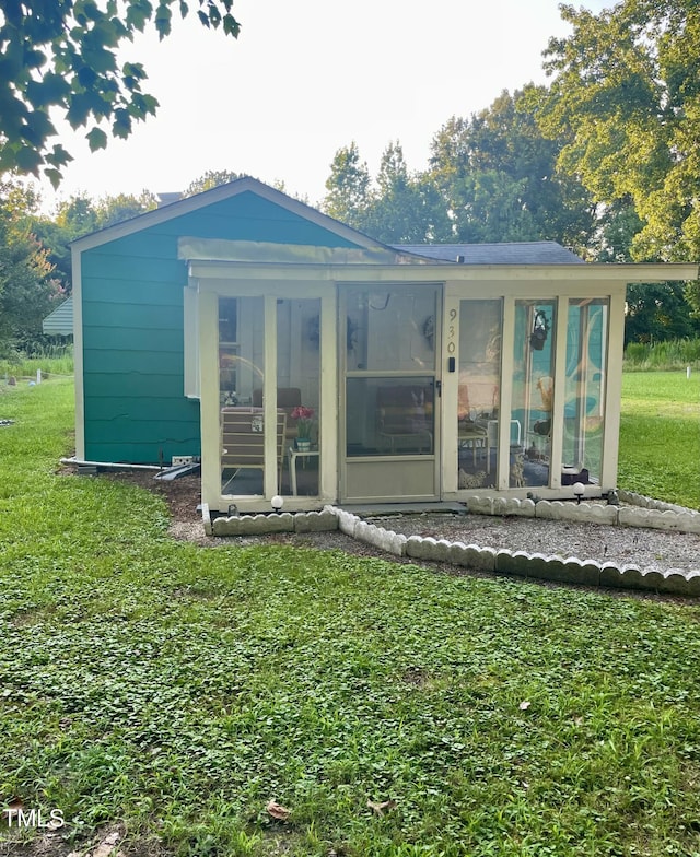 930 Rand St, Smithfield, NC 27577 - rear view of house with a sunroom and a lawn