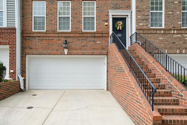 4104 Earl Grey Ct, Raleigh, NC 27612 - property entrance featuring an attached garage, concrete driveway, and brick siding