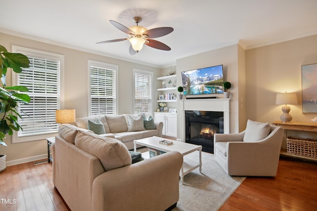 4104 Earl Grey Ct, Raleigh, NC 27612 - living room featuring ornamental molding, wood finished floors, a glass covered fireplace, and ceiling fan