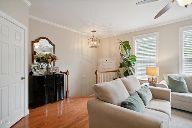 4104 Earl Grey Ct, Raleigh, NC 27612 - living room with crown molding, ceiling fan, light wood-type flooring, and a chandelier