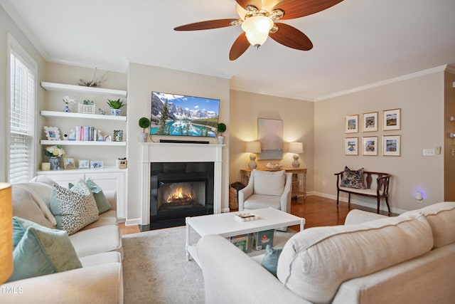 4104 Earl Grey Ct, Raleigh, NC 27612 - living room featuring wood finished floors, crown molding, a fireplace with flush hearth, and a ceiling fan