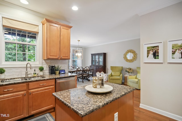 4104 Earl Grey Ct, Raleigh, NC 27612 - kitchen featuring stainless steel dishwasher, dark stone countertops, backsplash, crown molding, and wood finished floors