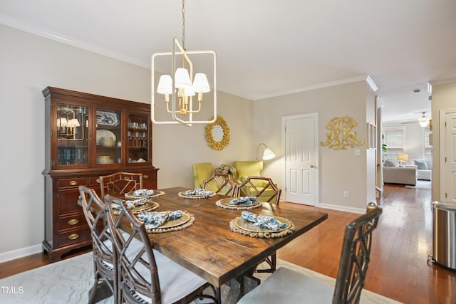 4104 Earl Grey Ct, Raleigh, NC 27612 - dining space featuring a chandelier, crown molding, and dark wood-style flooring