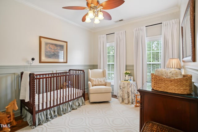 4104 Earl Grey Ct, Raleigh, NC 27612 - bedroom with ornamental molding, a crib, a wainscoted wall, and ceiling fan