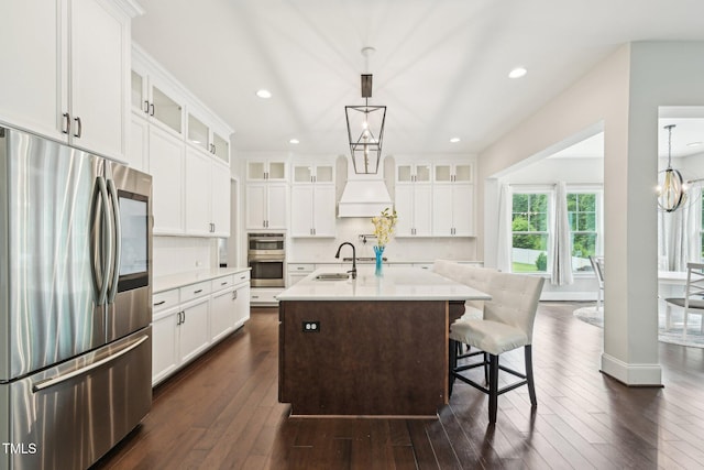 421 Gilpin Way, Cary, NC 27519 - kitchen with appliances with stainless steel finishes, light countertops, backsplash, a kitchen island with sink, and recessed lighting