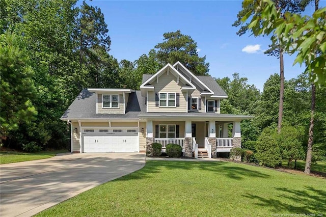 57 Spring Water Ct, Spring Lake, NC 28390 - craftsman house featuring covered porch, driveway, a front lawn, an attached garage, and view of wooded area