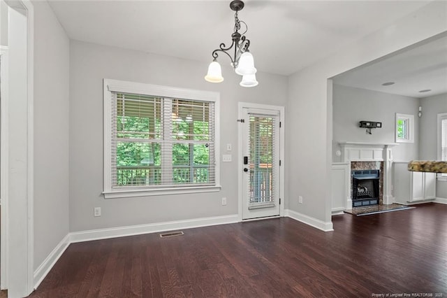57 Spring Water Ct, Spring Lake, NC 28390 - unfurnished dining area with healthy amount of natural light, wood finished floors, a fireplace, and a chandelier