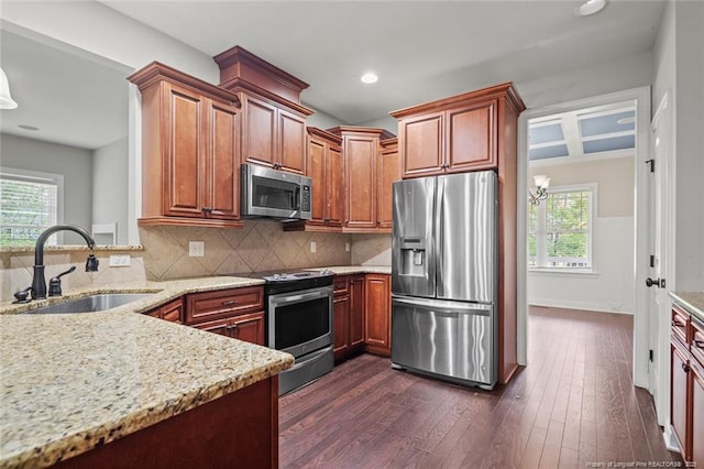 57 Spring Water Ct, Spring Lake, NC 28390 - kitchen with appliances with stainless steel finishes, light stone counters, dark wood-style flooring, decorative backsplash, and recessed lighting