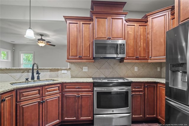 57 Spring Water Ct, Spring Lake, NC 28390 - kitchen with appliances with stainless steel finishes, light stone countertops, a ceiling fan, and tasteful backsplash