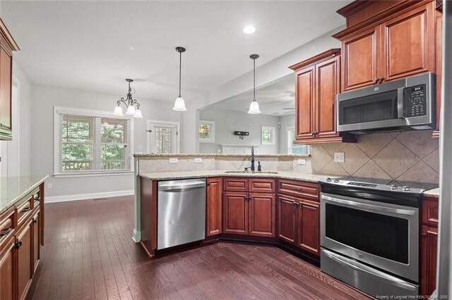 57 Spring Water Ct, Spring Lake, NC 28390 - kitchen with appliances with stainless steel finishes, a peninsula, healthy amount of natural light, dark wood-type flooring, and recessed lighting