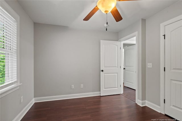 57 Spring Water Ct, Spring Lake, NC 28390 - unfurnished bedroom featuring multiple windows, wood finished floors, and a ceiling fan