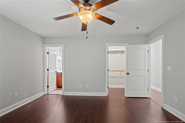 57 Spring Water Ct, Spring Lake, NC 28390 - unfurnished bedroom featuring a spacious closet, dark wood finished floors, a closet, ensuite bath, and ceiling fan