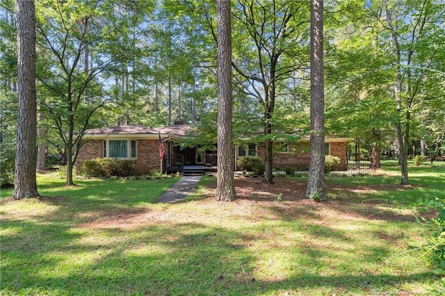 5945 Muscat Rd, Hope Mills, NC 28348 - view of front of house with brick siding, a front yard, and a porch