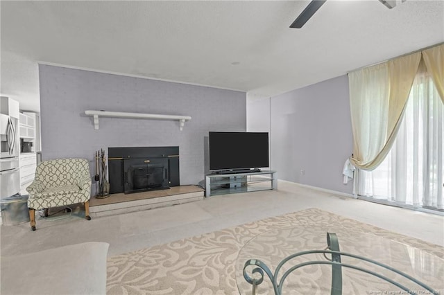 5945 Muscat Rd, Hope Mills, NC 28348 - carpeted living room featuring ceiling fan and a fireplace with raised hearth