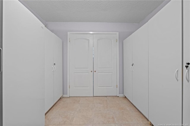 5945 Muscat Rd, Hope Mills, NC 28348 - hall featuring a textured ceiling and light tile patterned flooring