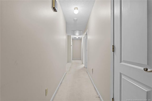 5945 Muscat Rd, Hope Mills, NC 28348 - hallway with attic access, a textured ceiling, and light carpet