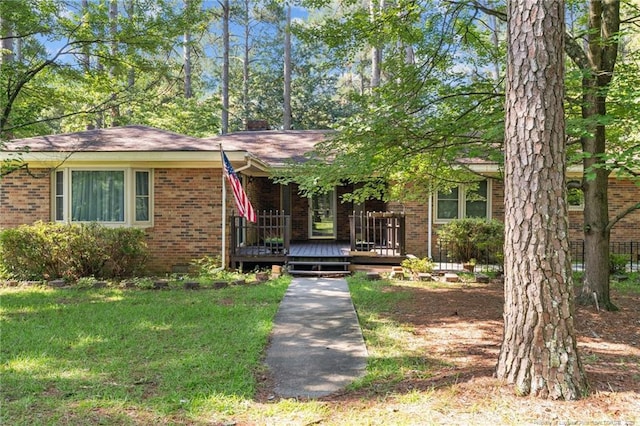 5945 Muscat Rd, Hope Mills, NC 28348 - view of front facade featuring brick siding, covered porch, and a front lawn