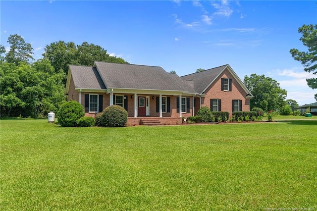 1438 Division Pl, Fayetteville, NC 28312 - view of front of property with a porch, brick siding, and a front lawn