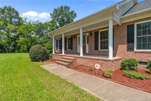 1438 Division Pl, Fayetteville, NC 28312 - entrance to property with brick siding, a lawn, and a porch