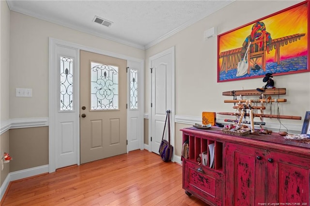 1438 Division Pl, Fayetteville, NC 28312 - foyer entrance featuring light wood-style floors, ornamental molding, and a textured ceiling