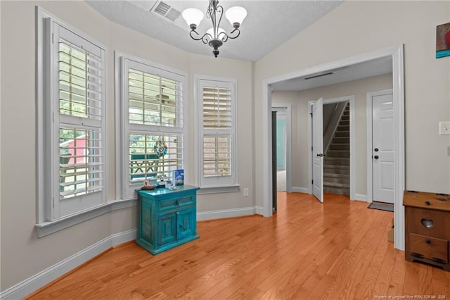 1438 Division Pl, Fayetteville, NC 28312 - empty room with a chandelier, light wood finished floors, and stairway