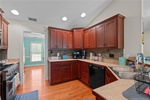 1438 Division Pl, Fayetteville, NC 28312 - kitchen featuring black dishwasher, high end stove, light wood-style flooring, light countertops, and lofted ceiling