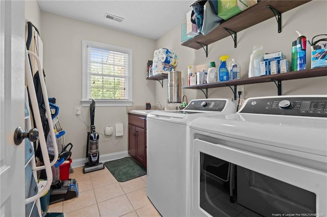 1438 Division Pl, Fayetteville, NC 28312 - laundry room with cabinet space, independent washer and dryer, and light tile patterned floors