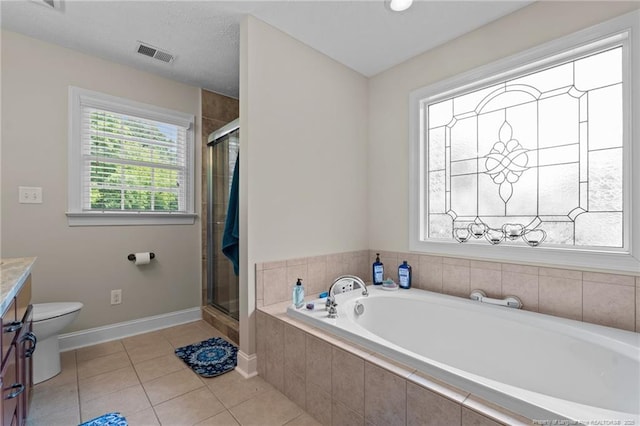 1438 Division Pl, Fayetteville, NC 28312 - bathroom with a garden tub, vanity, a stall shower, and tile patterned floors