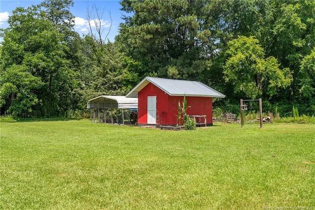 1438 Division Pl, Fayetteville, NC 28312 - view of grassy yard featuring a detached carport and an outbuilding